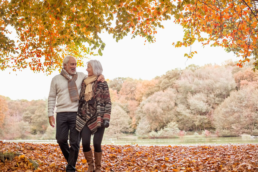 Older couple walking in park