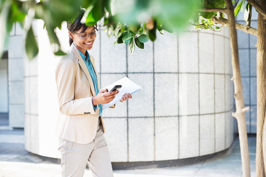 Businesswoman using cell phone outdoors