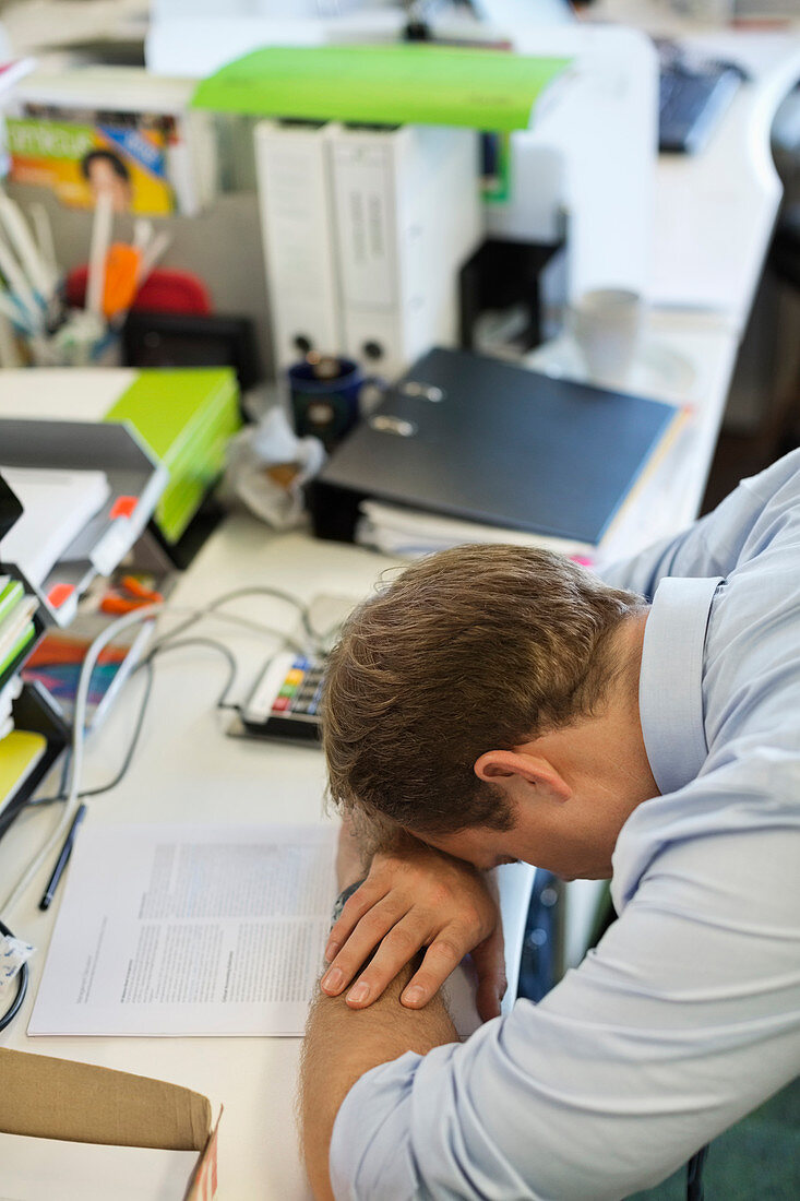 Businessman resting head on desk