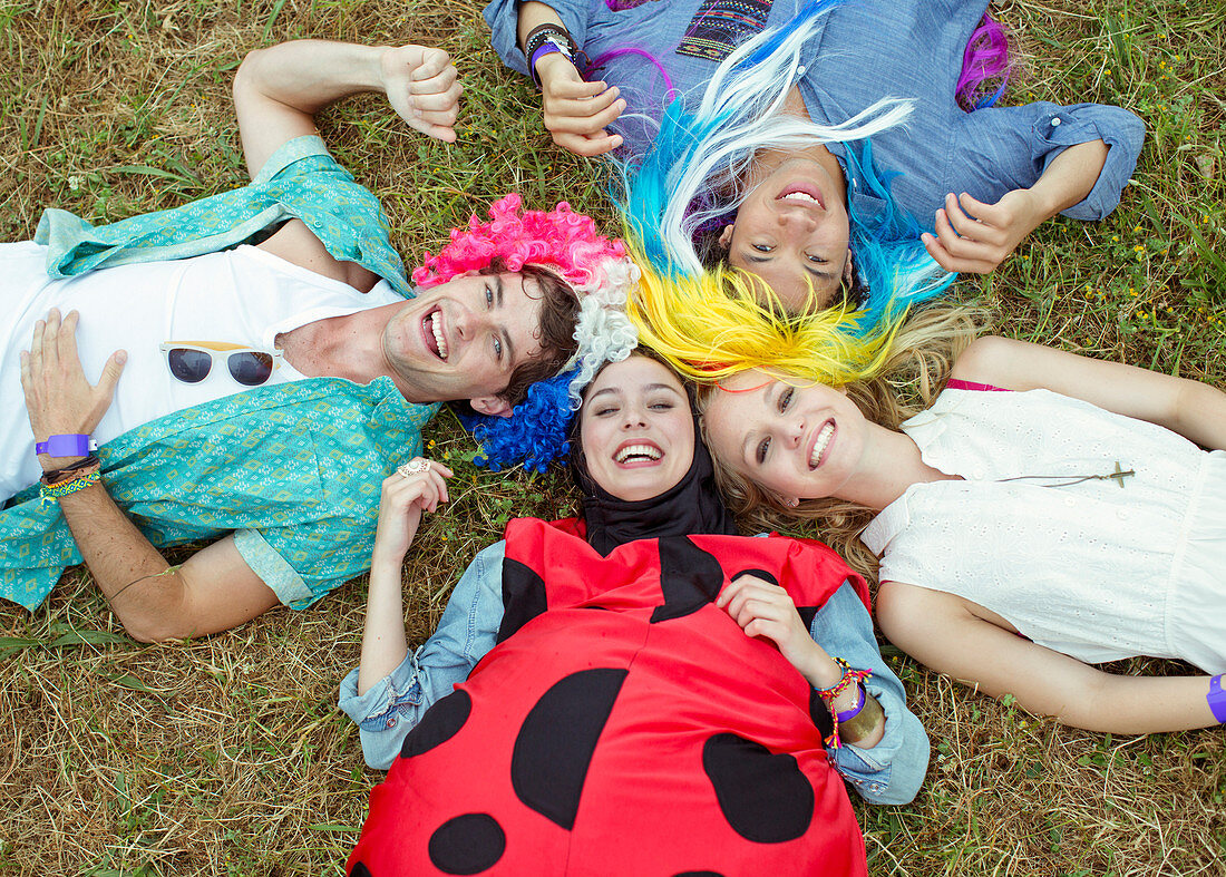 Friends in costumes laying in grass