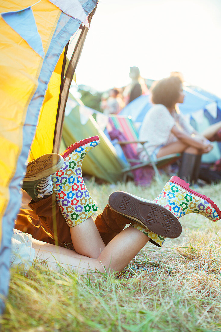 Couple's legs sticking out of tent