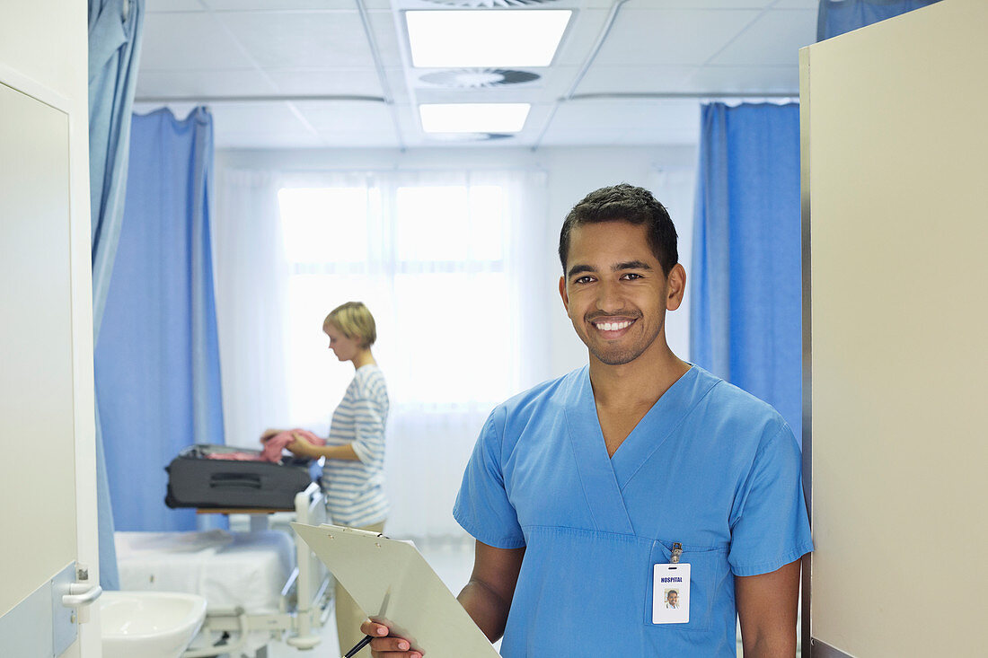 Nurse holding clipboard in hospital room