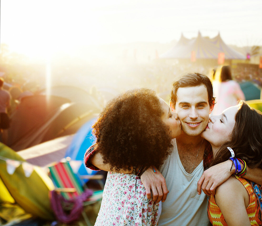 Women kissing man's cheek