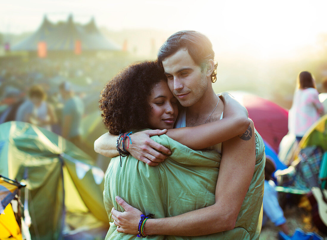 Couple in sleeping bag hugging