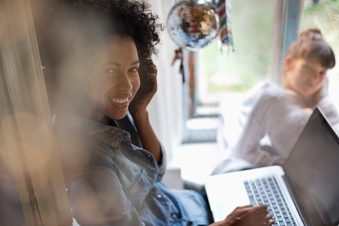 Woman using laptop in window