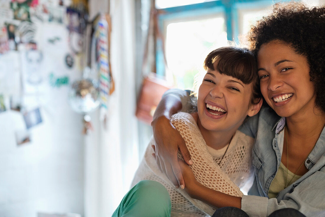 Women hugging in bedroom