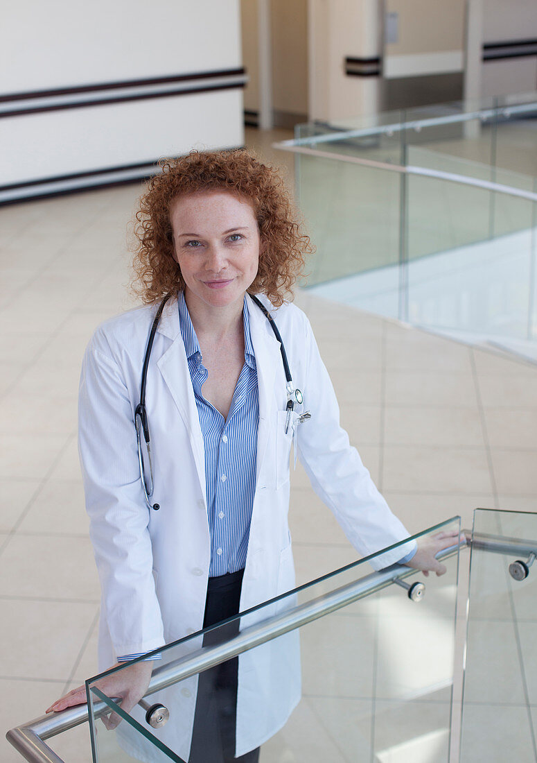 Doctor leaning on banister hallway