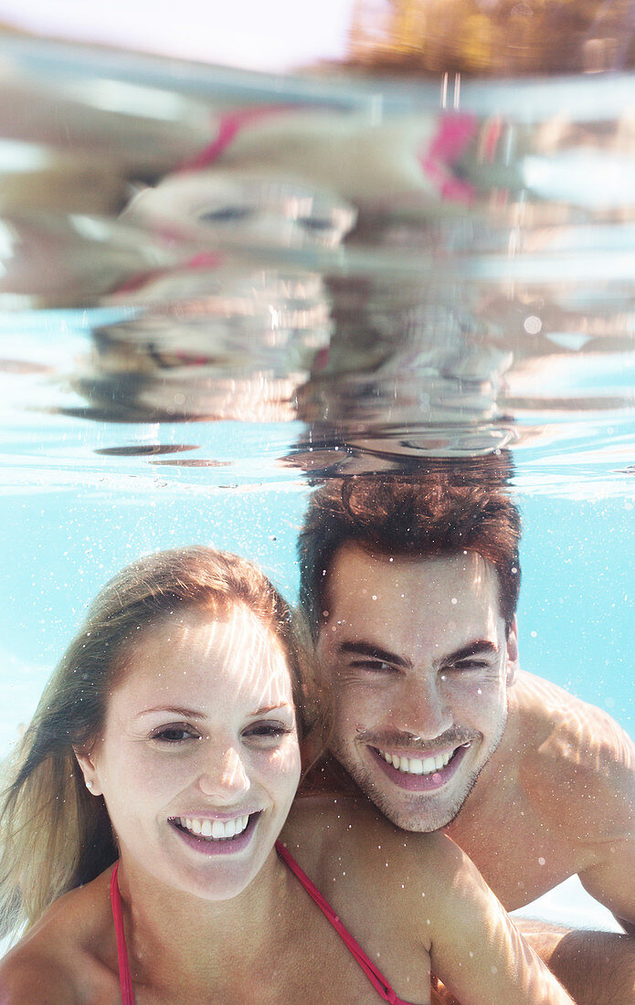 Couple smiling in swimming pool
