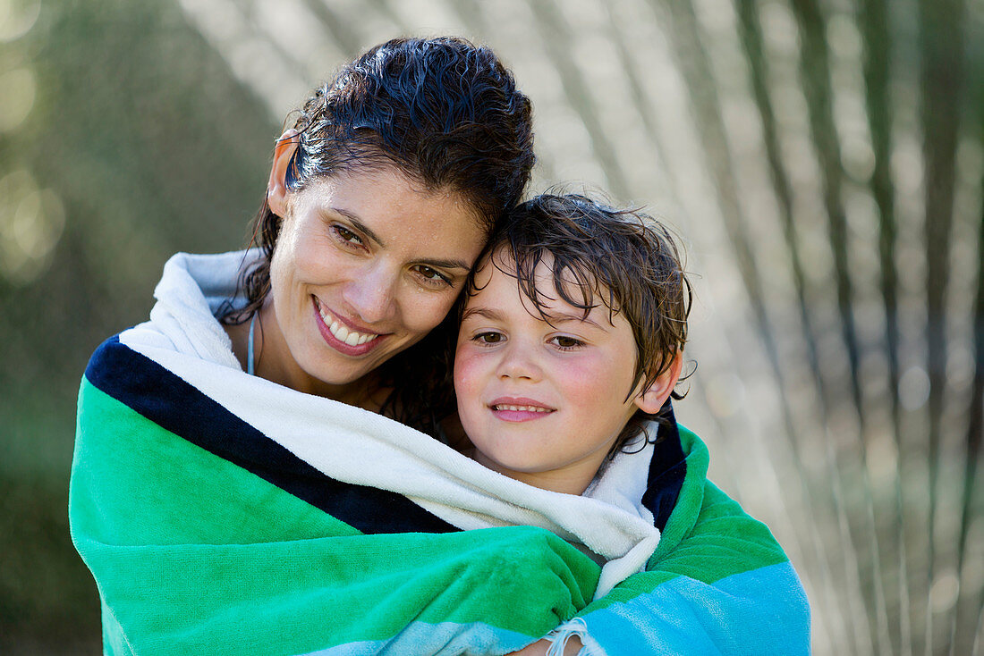 Mother and son wrapped in towel