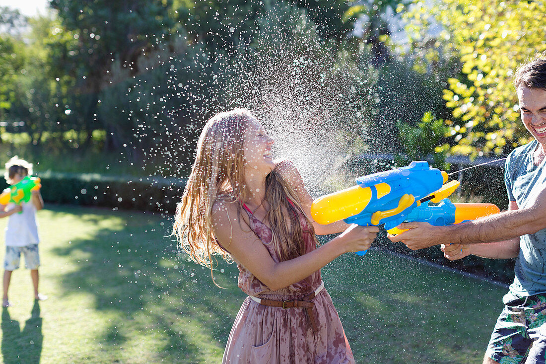 Couple playing with water guns