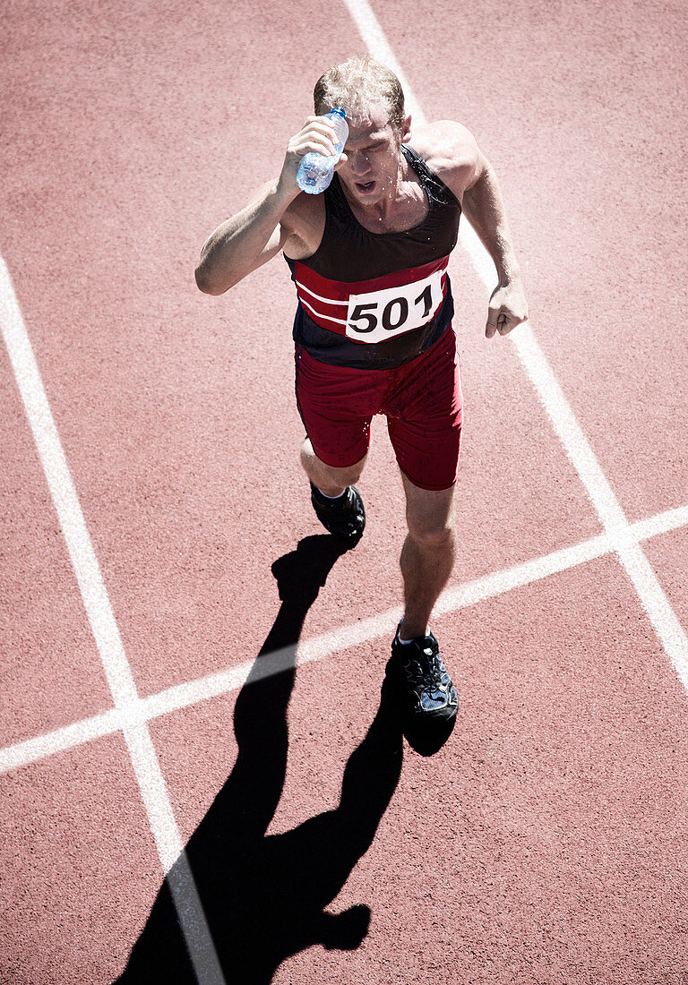 Runner pouring water overhead on track