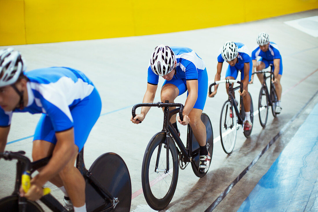 Track cycling team riding in velodrome