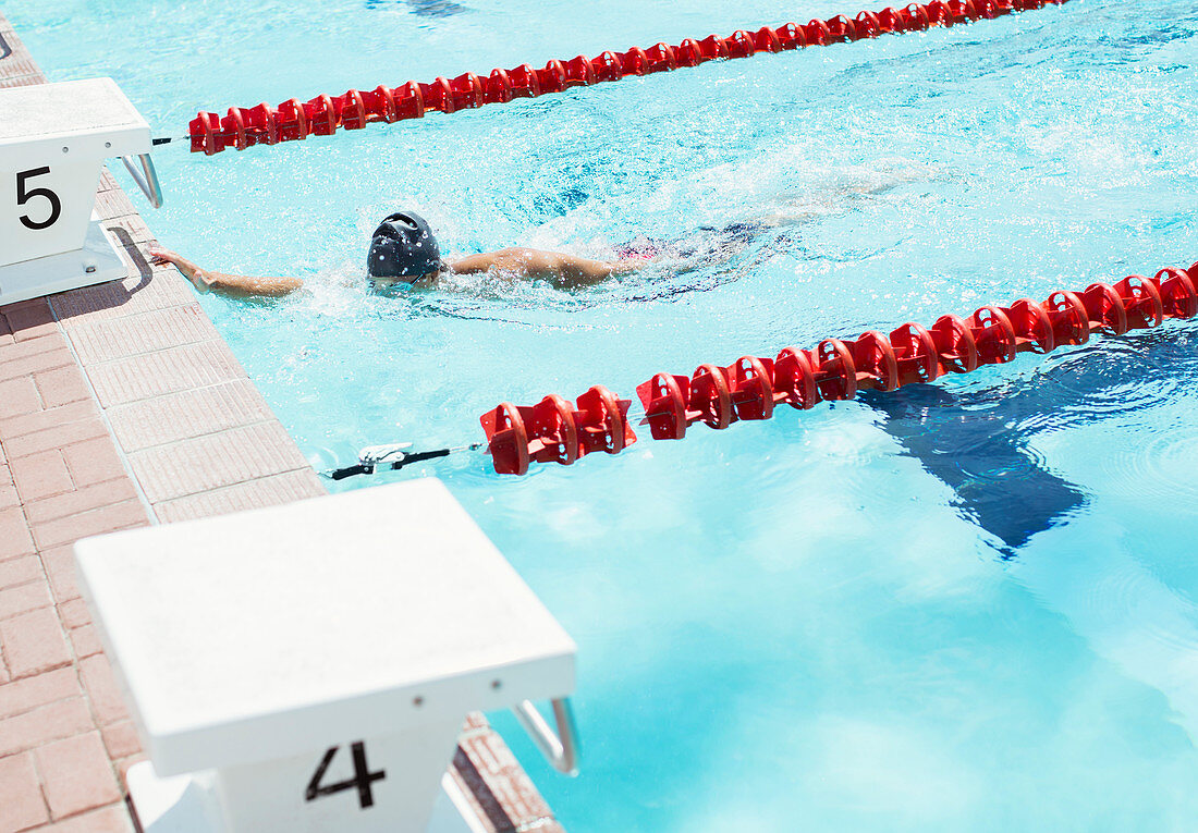 Swimmer touching edge of pool