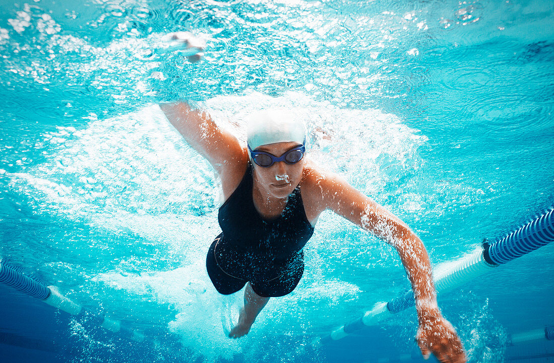 Swimmer racing in pool