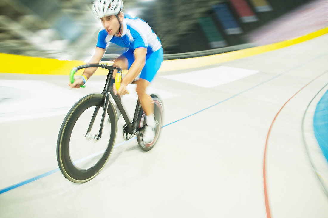 Track cyclist riding in velodrome