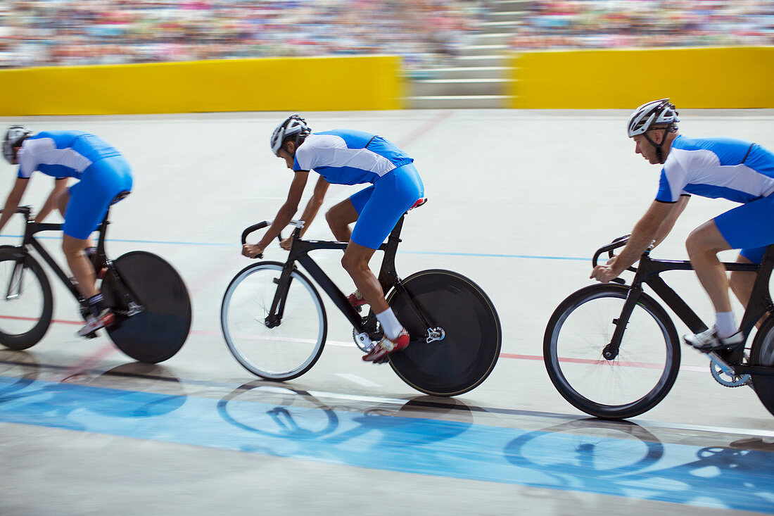 Track cycling team riding in velodrome