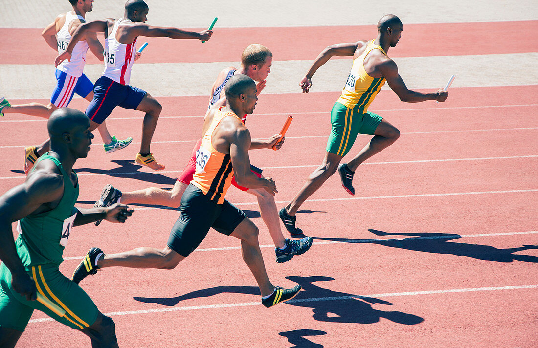 Relay runners racing on track