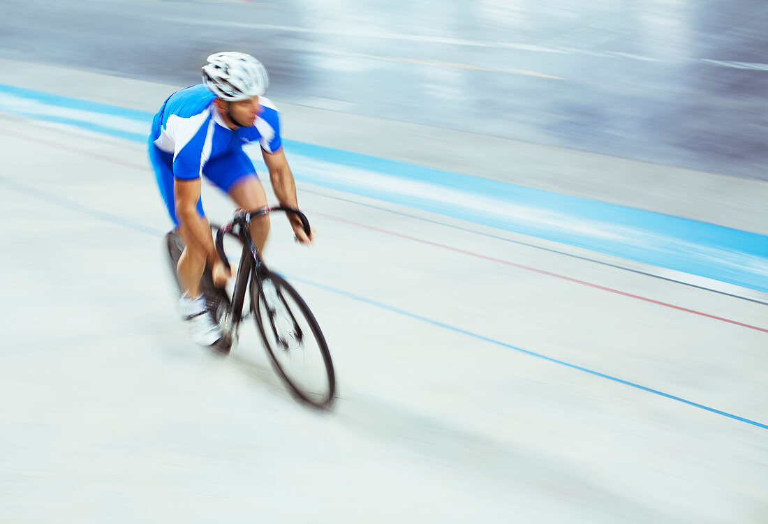 Track cyclist riding in velodrome