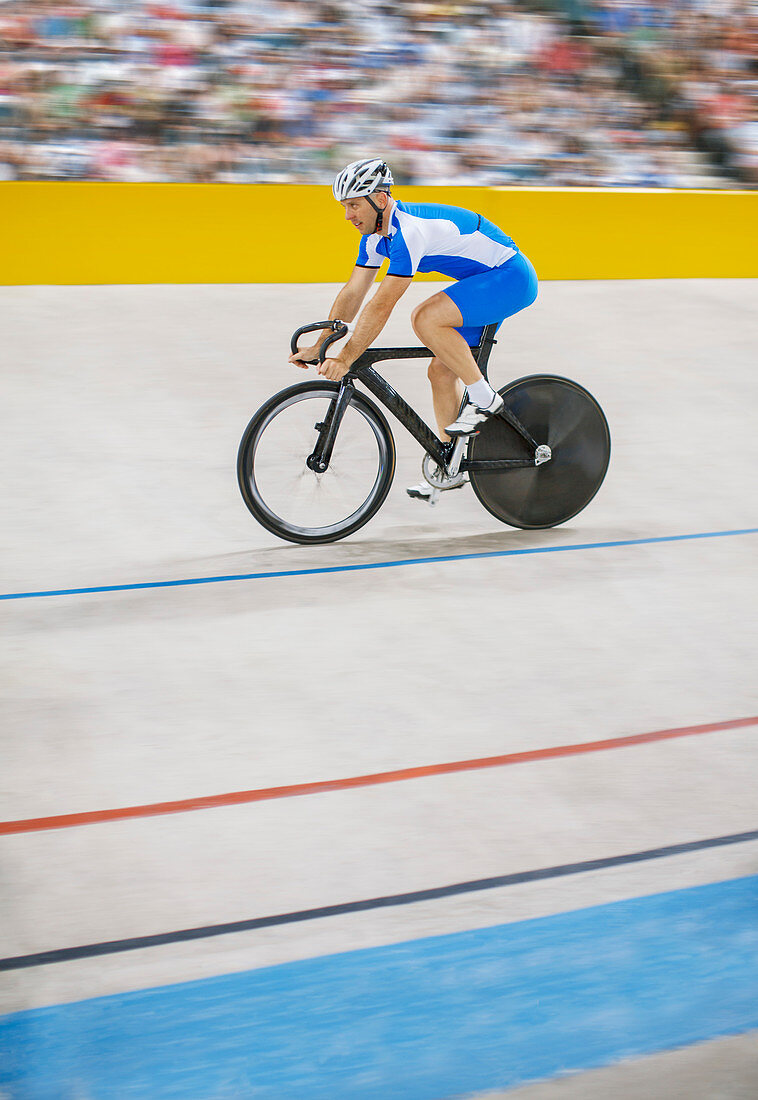 Track cyclist riding in velodrome