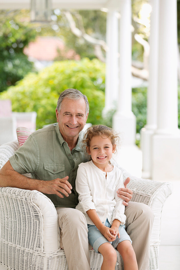 Older man with granddaughter on porch