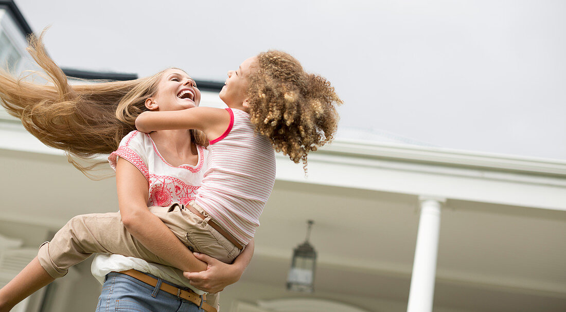 Mother and daughter playing outdoors