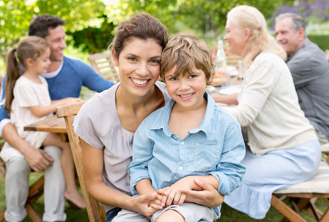 Mother and son smiling in backyard