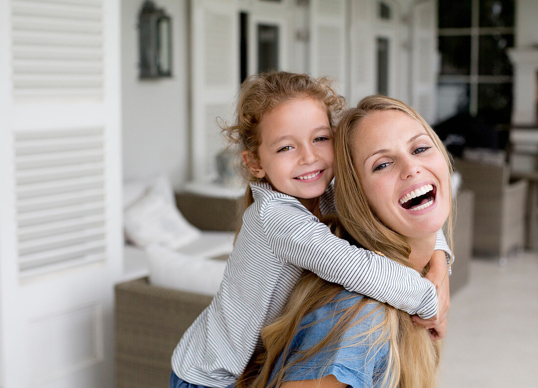 Mother and daughter playing on porch