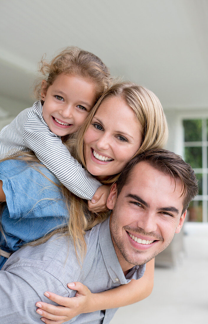 Family smiling together on porch