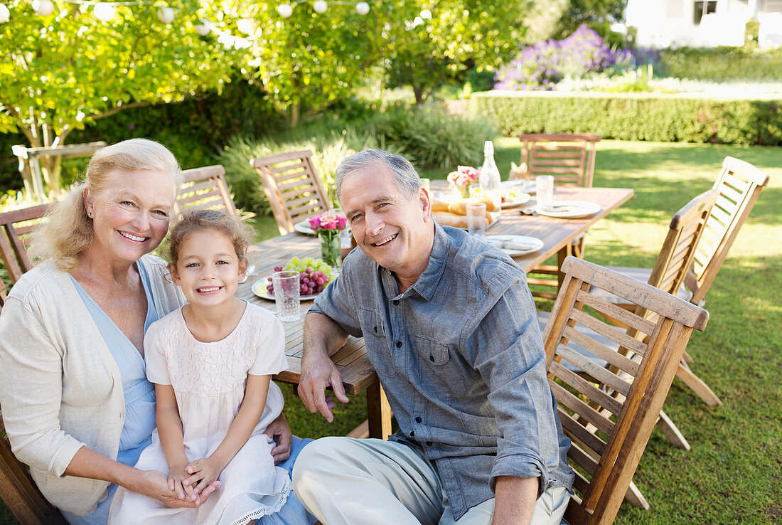 Older couple and granddaughter smiling