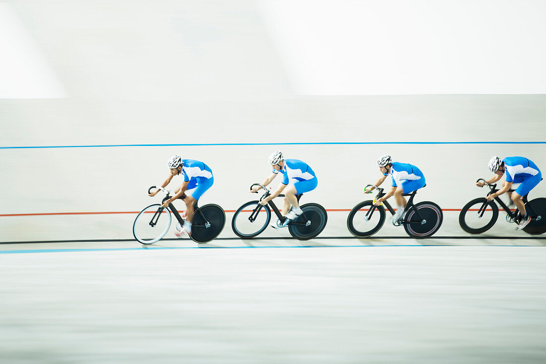 Cyclists racing around velodrome