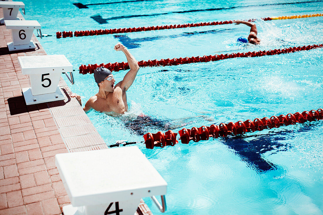 Swimmer celebrating in pool