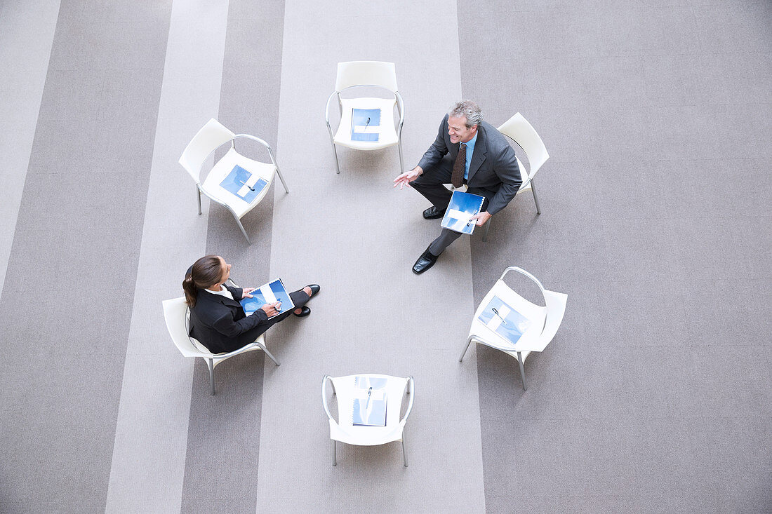 Businessman and businesswoman talking