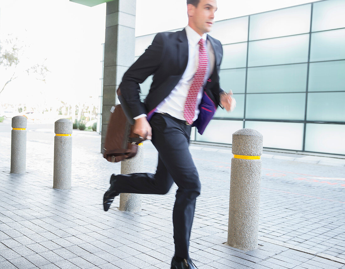 Businessman with briefcase running