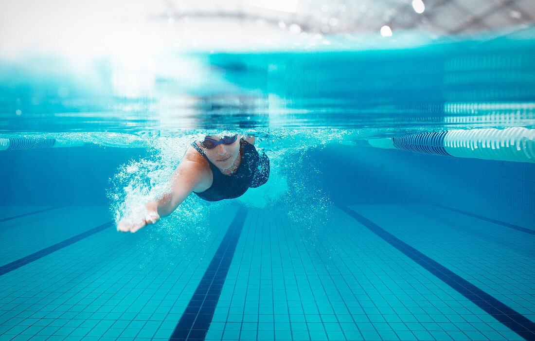 Swimmer racing in pool