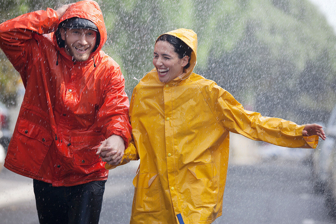 Happy couple holding hands and running