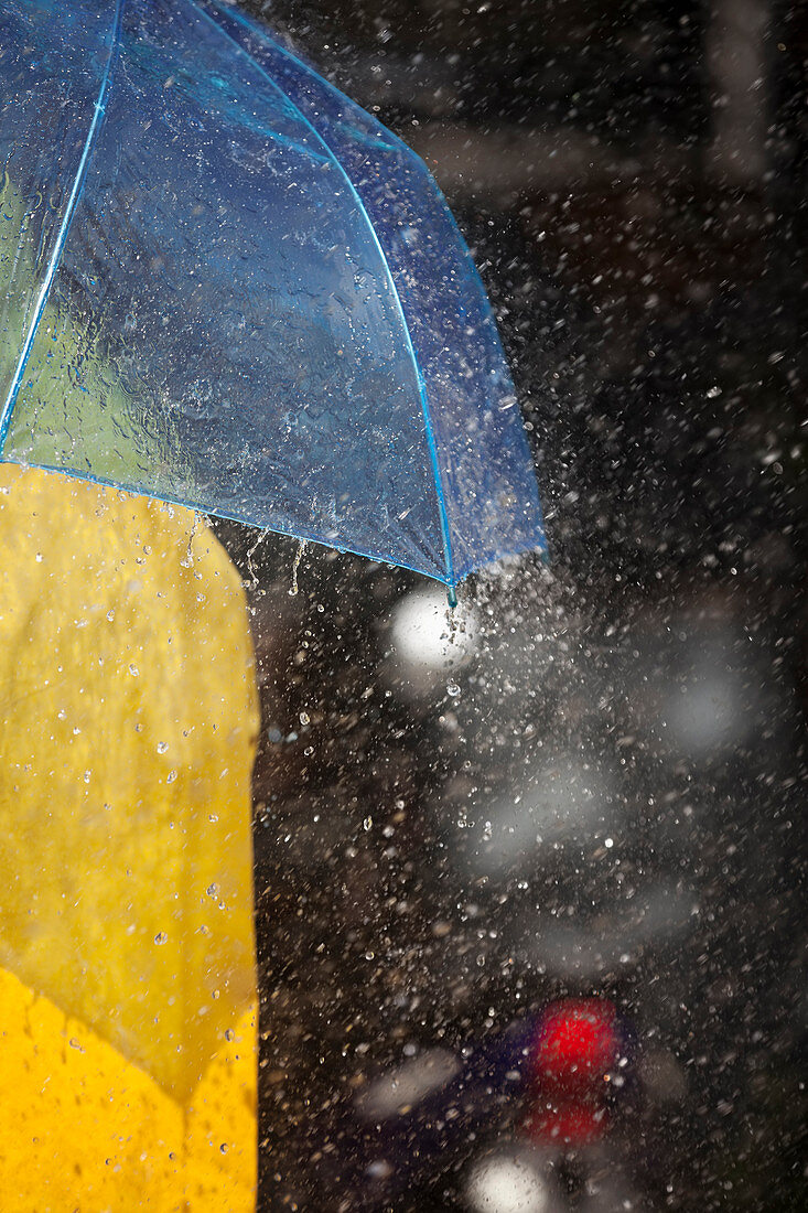 Close up of woman under umbrella in rain