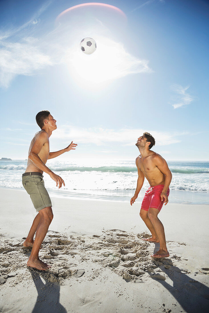 Men in swim trunks on beach