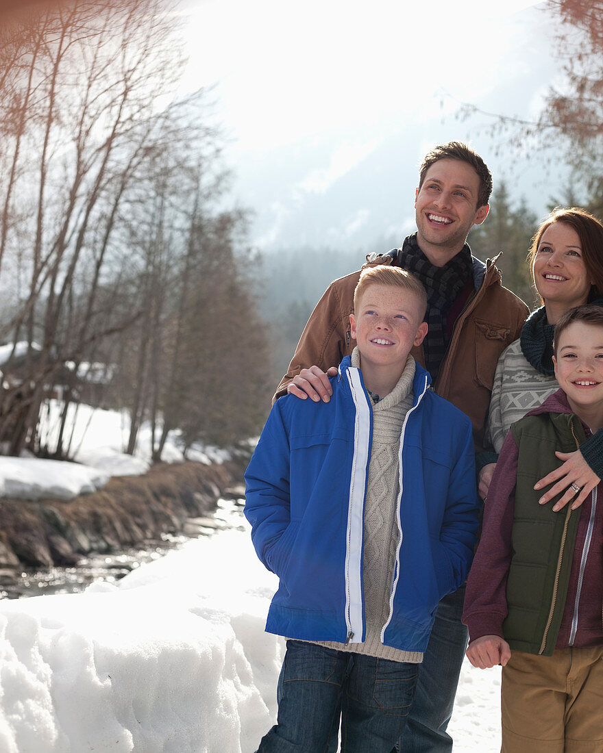 Happy family standing in snow