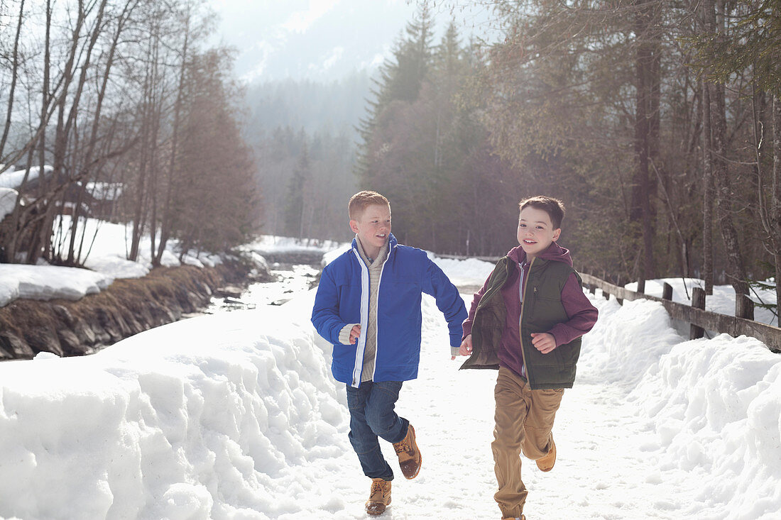 Boys holding hands and runningy lane