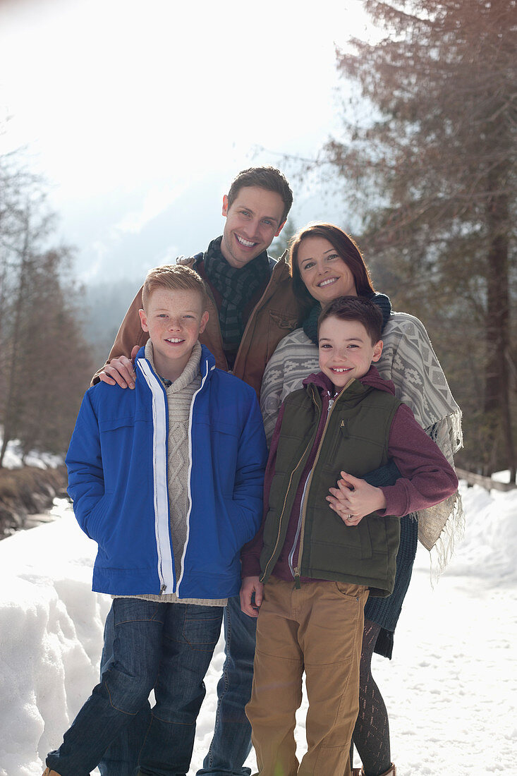 Portrait of smiling family in snowy lane