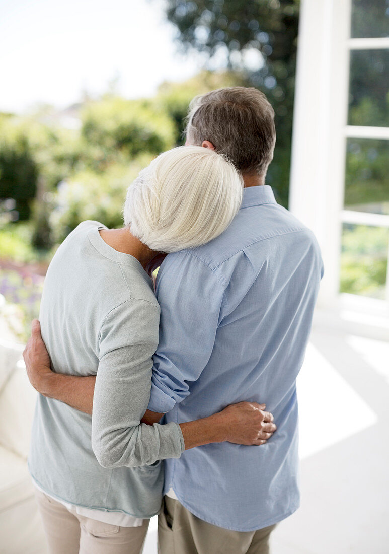 Senior couple hugging on patio