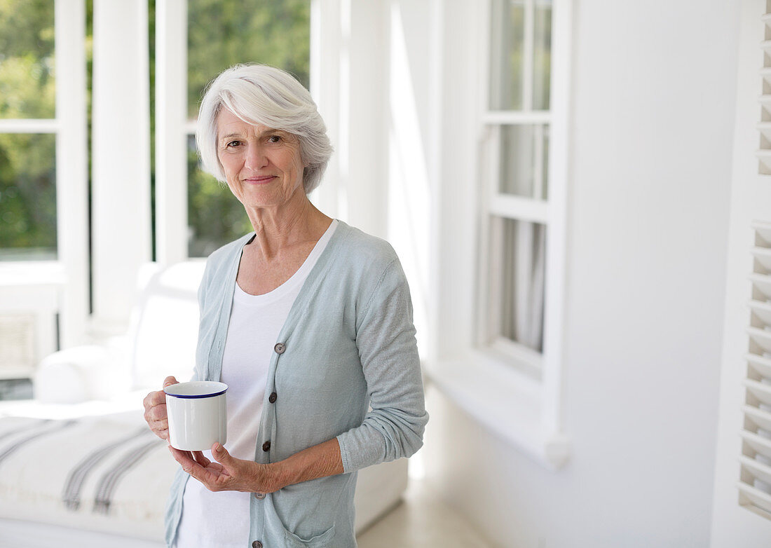 Senior woman holding cup of coffee