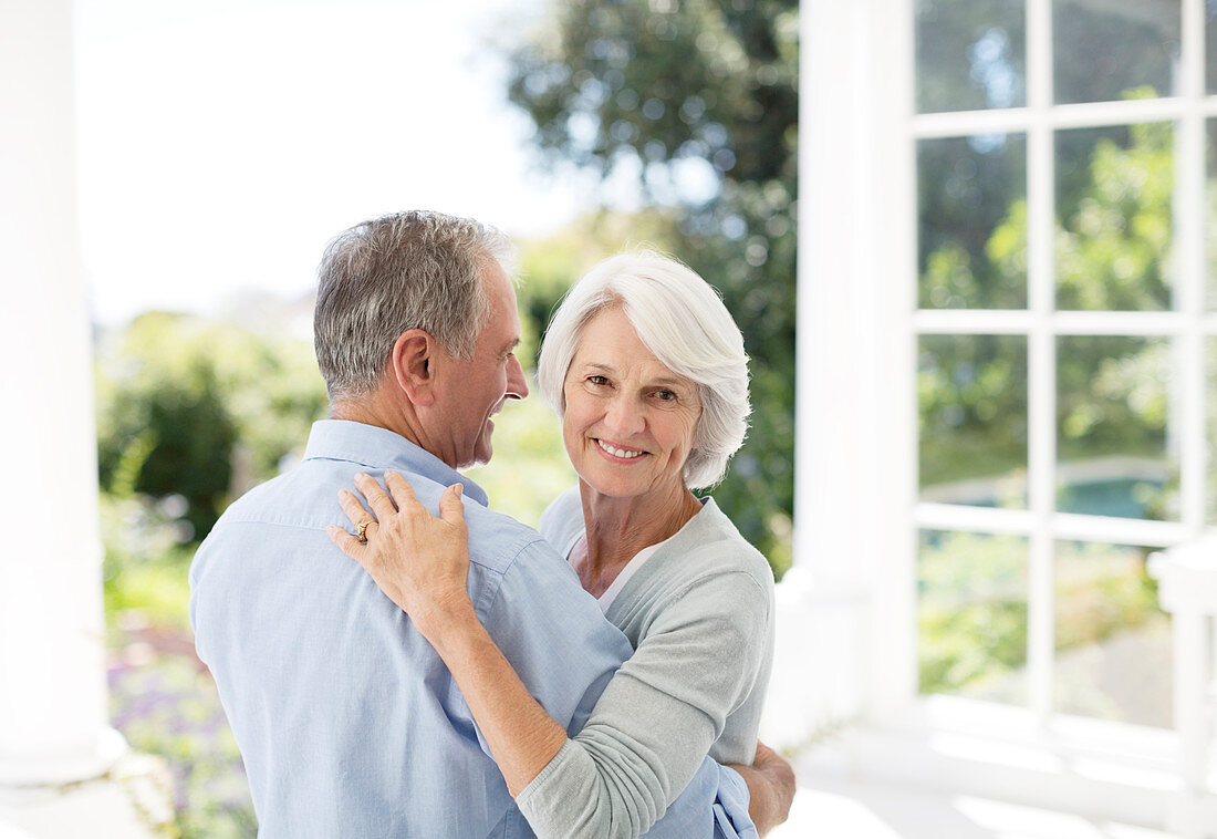 Senior couple dancing on patio