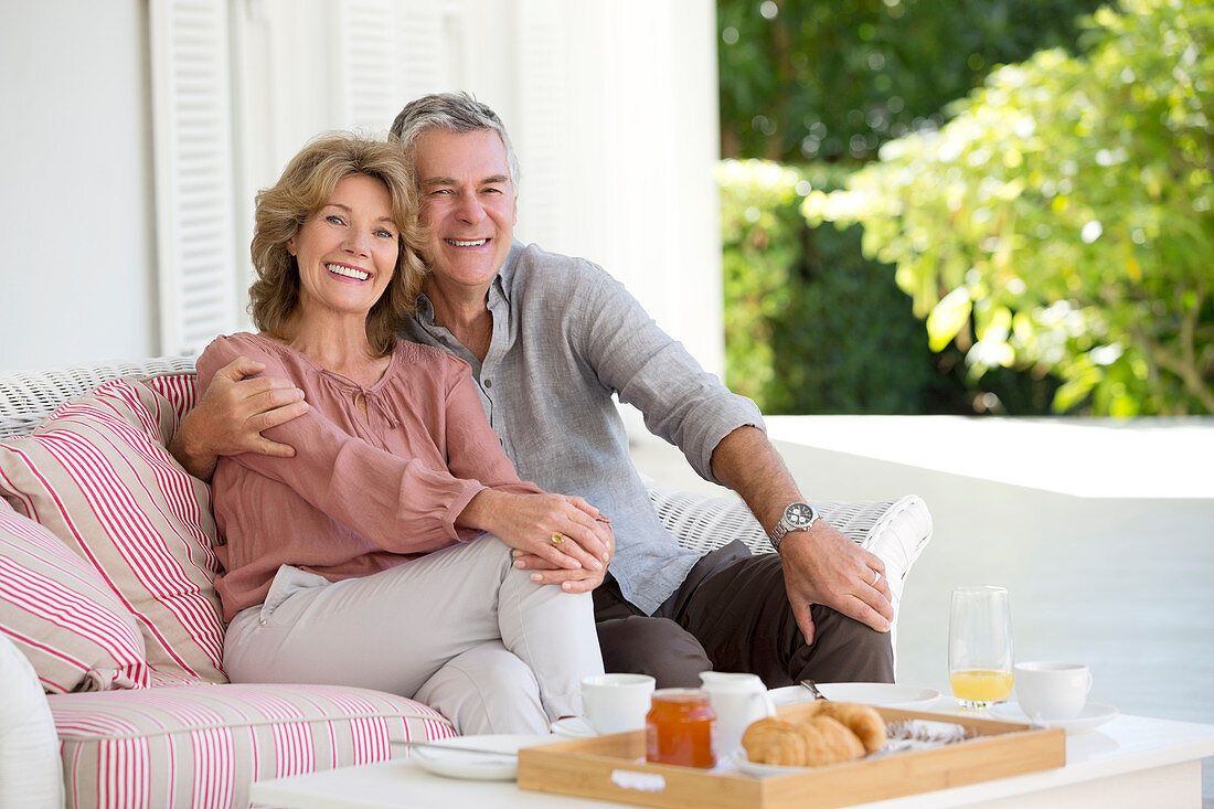 Smiling senior couple enjoying breakfast