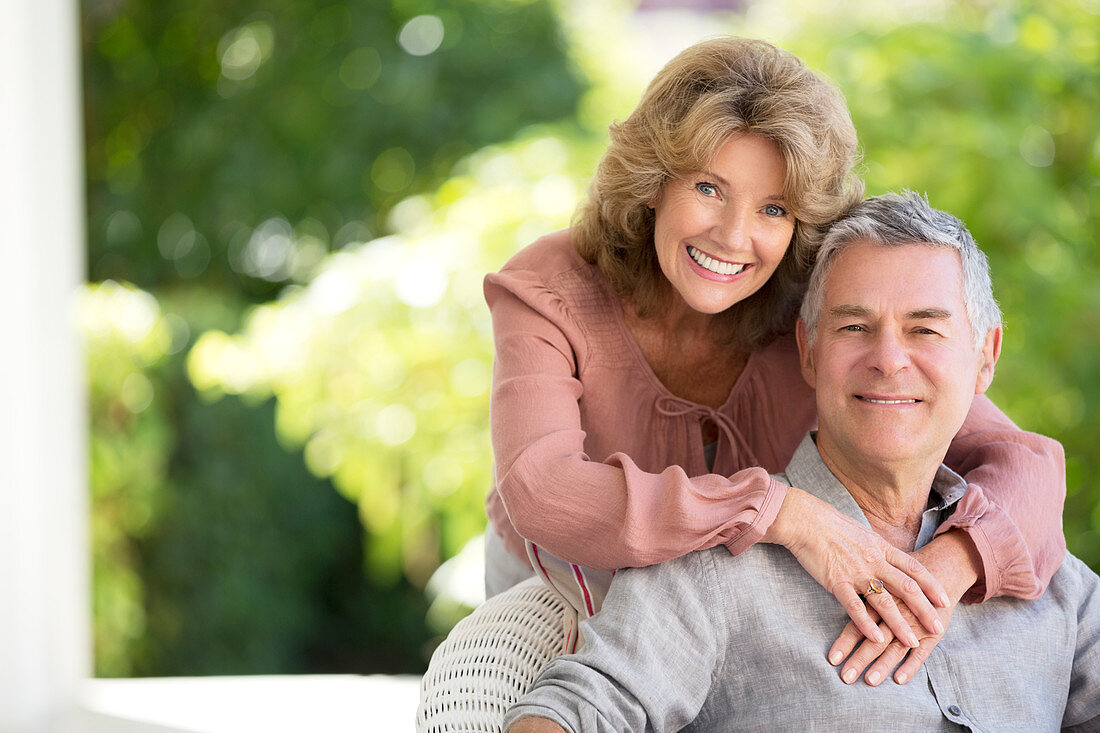 Senior couple hugging on patio