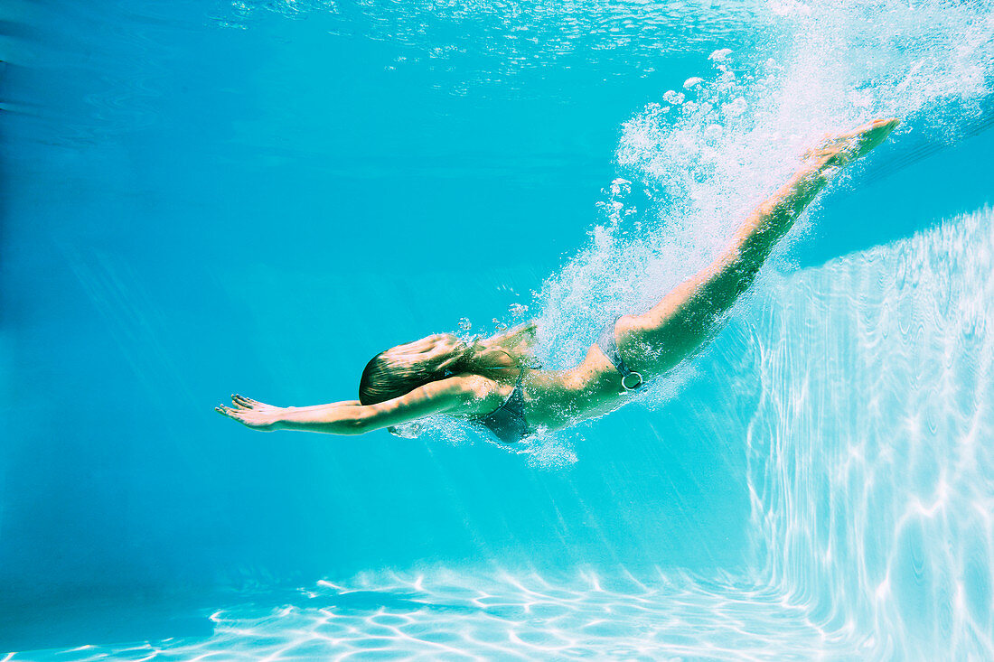 Woman diving into swimming pool