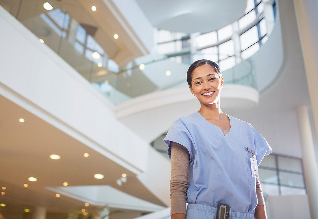 Smiling nurse in hospital atrium