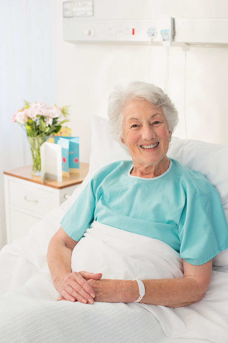 Smiling aging patient in hospital bed