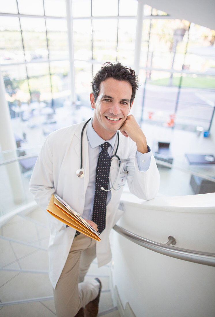 Smiling doctor on stairs in hospital