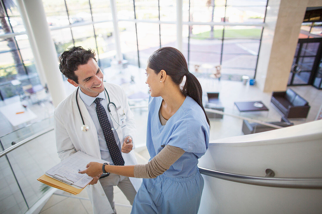 Doctor and nurse talking on staircase